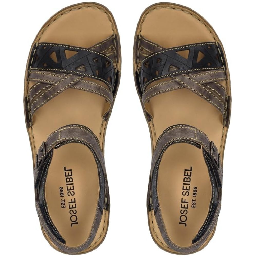 A pair of Josef Seibel strappy sandals shown from a top-down view. The sandals feature dark brown and navy cutout leather straps over a tan footbed, with the brand name 'JOSEF SEIBEL' printed on the insole.