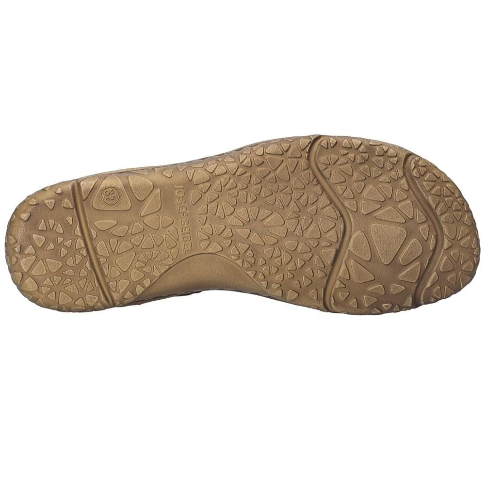A top-down view of a tan textured shoe sole, showing the tread pattern and embossed branding on a plain white background.