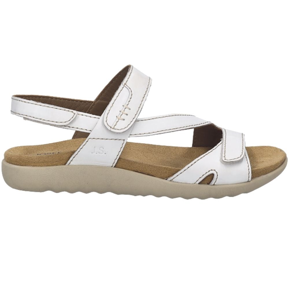 A white leather strappy sandal with a tan footbed and beige sole, shown from a side profile view on a white background.