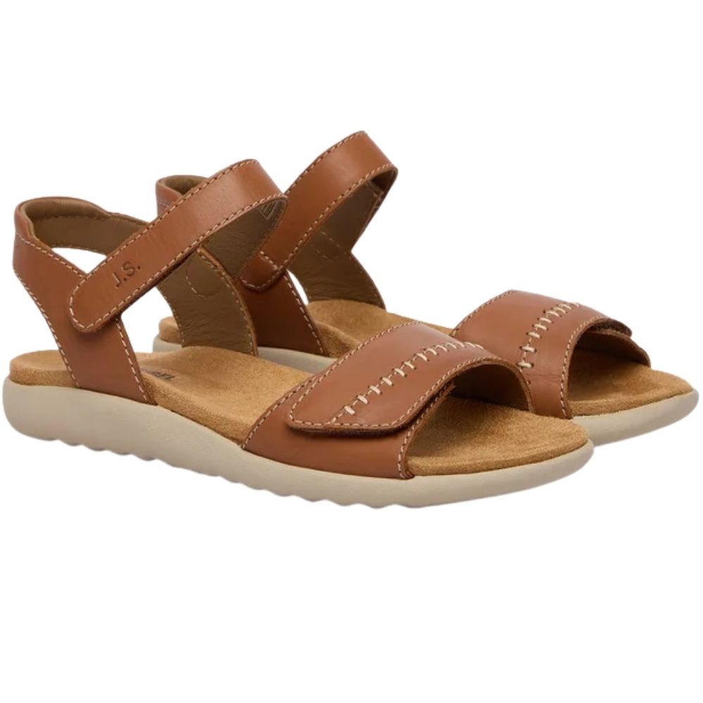 A pair of women's flat sandals in tan leather with adjustable straps and a contoured off-white sole, shown on a plain white background.