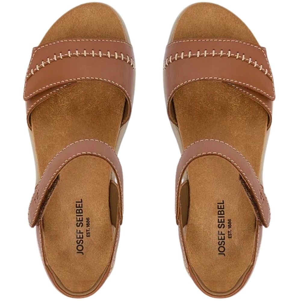 A pair of Josef Seibel wedge sandals shown from a top-down view, featuring a tan leather upper with contrast stitching and a tan footbed.