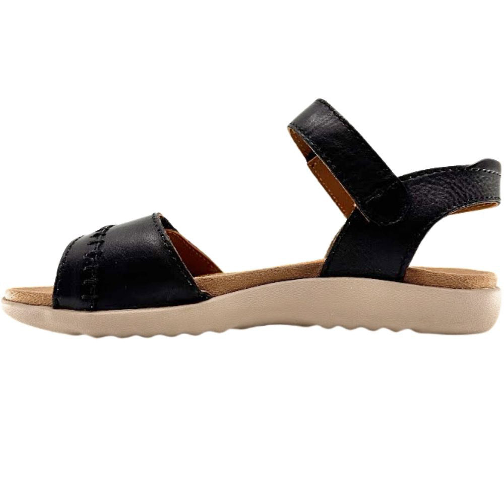 A black leather sandal with an adjustable ankle strap and a thick beige sole, shown in a side profile view against a white background.