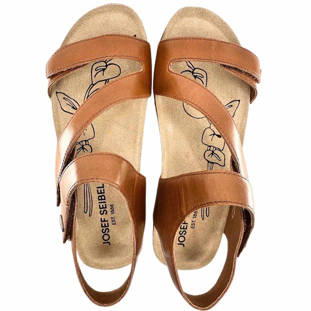 A pair of Josef Seibel leather sandals with a warm brown finish, featuring criss-cross straps and an open toe, shown from a top-down view on a white background.