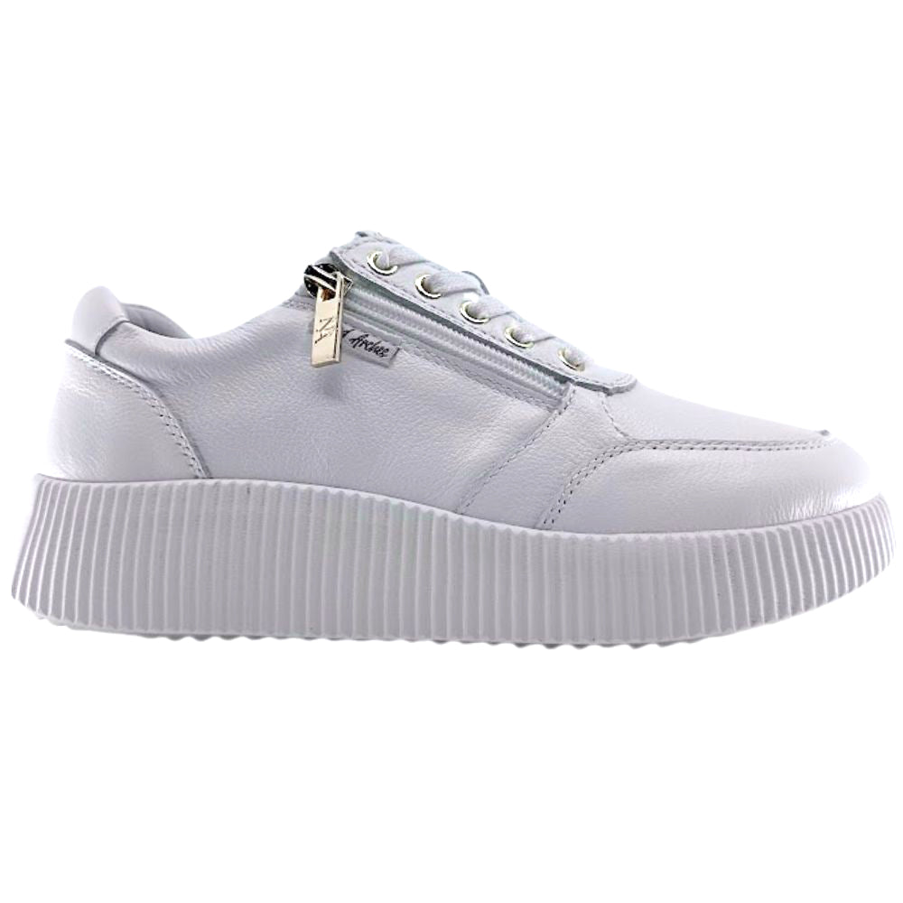 White sneaker with a platform sole on a white background