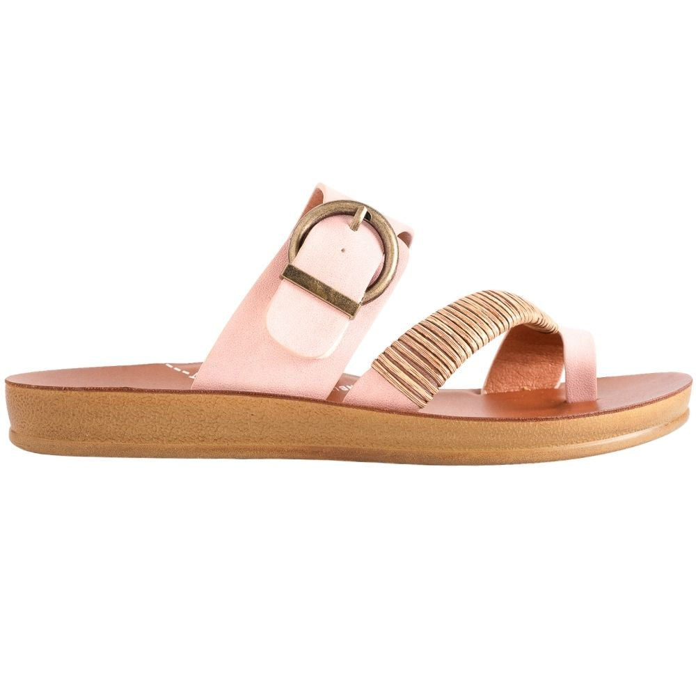 A single women's slide sandal in light pink, featuring a wide strap with a bronze buckle, a braided toe strap, and a tan sole on a white background.
