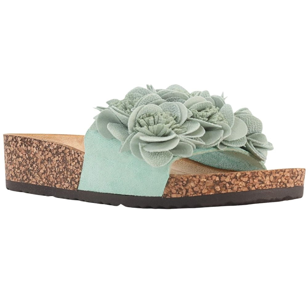 A single women's slide sandal with a mint strap adorned with large, layered faux flowers, set on a brown cork wedge heel and sole with a black outsole, shown against a plain white background.