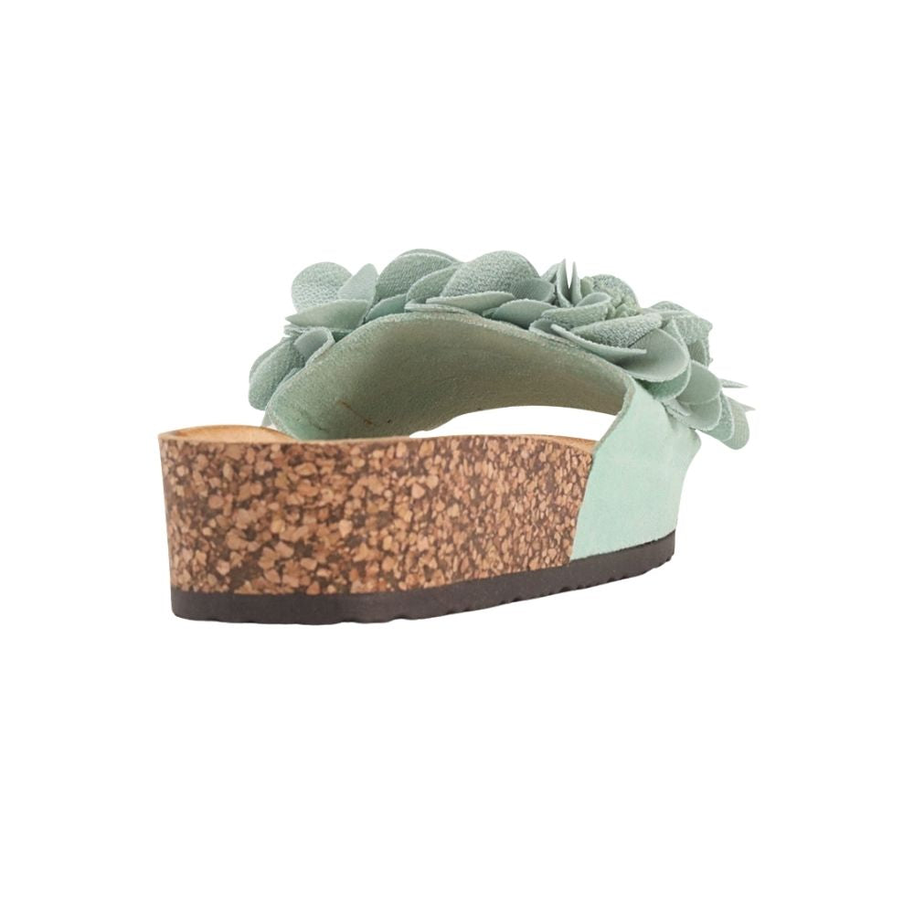 A mint wedge sandal featuring a large layered fabric flower on the strap and a textured cork wedge heel, shown against a plain white background.