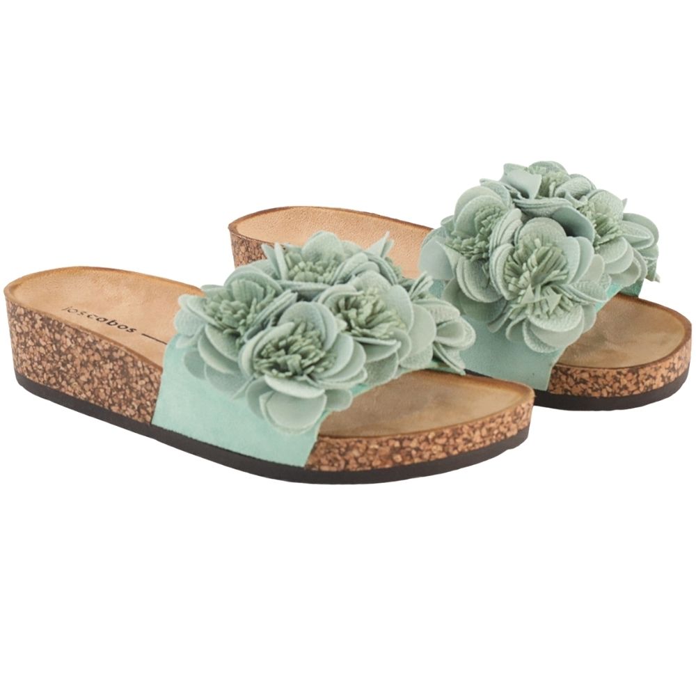 A pair of women's slide sandals with mint floral embellishments on the straps and a natural cork wedge heel and sole, shown against a plain white background.