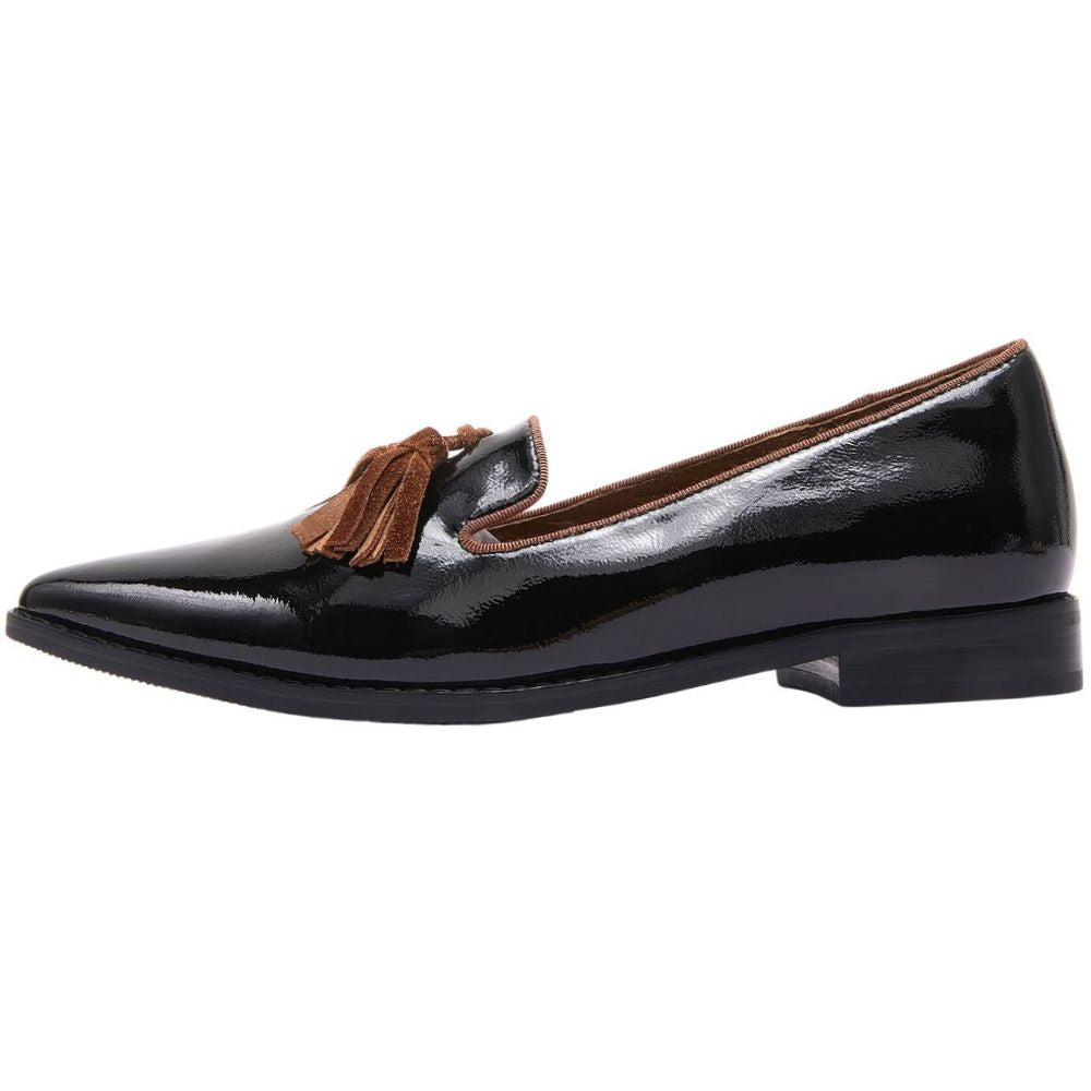 Black patent leather loafer with a decorative buckle on a white background