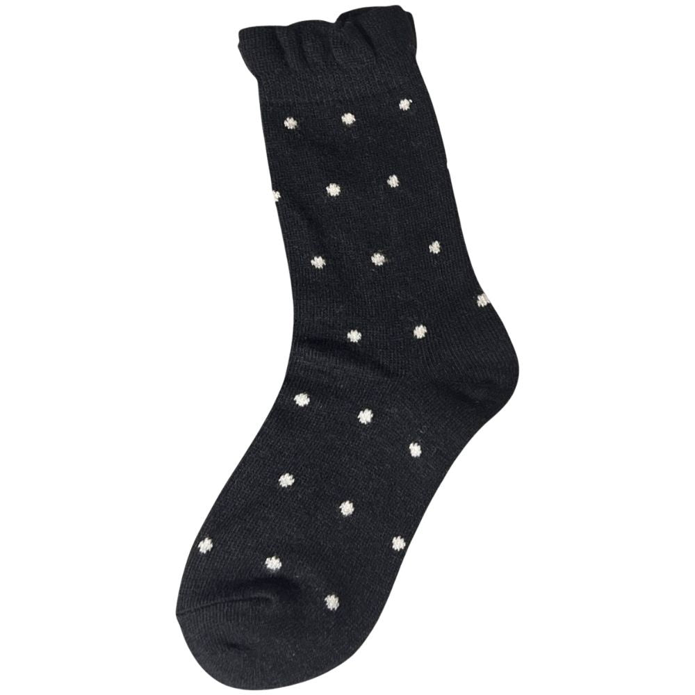 Black sock with white spots and frill cuff on a white background