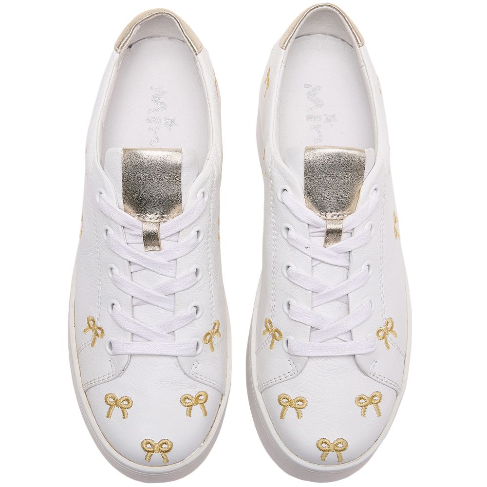 White sneakers with gold bows on a white background