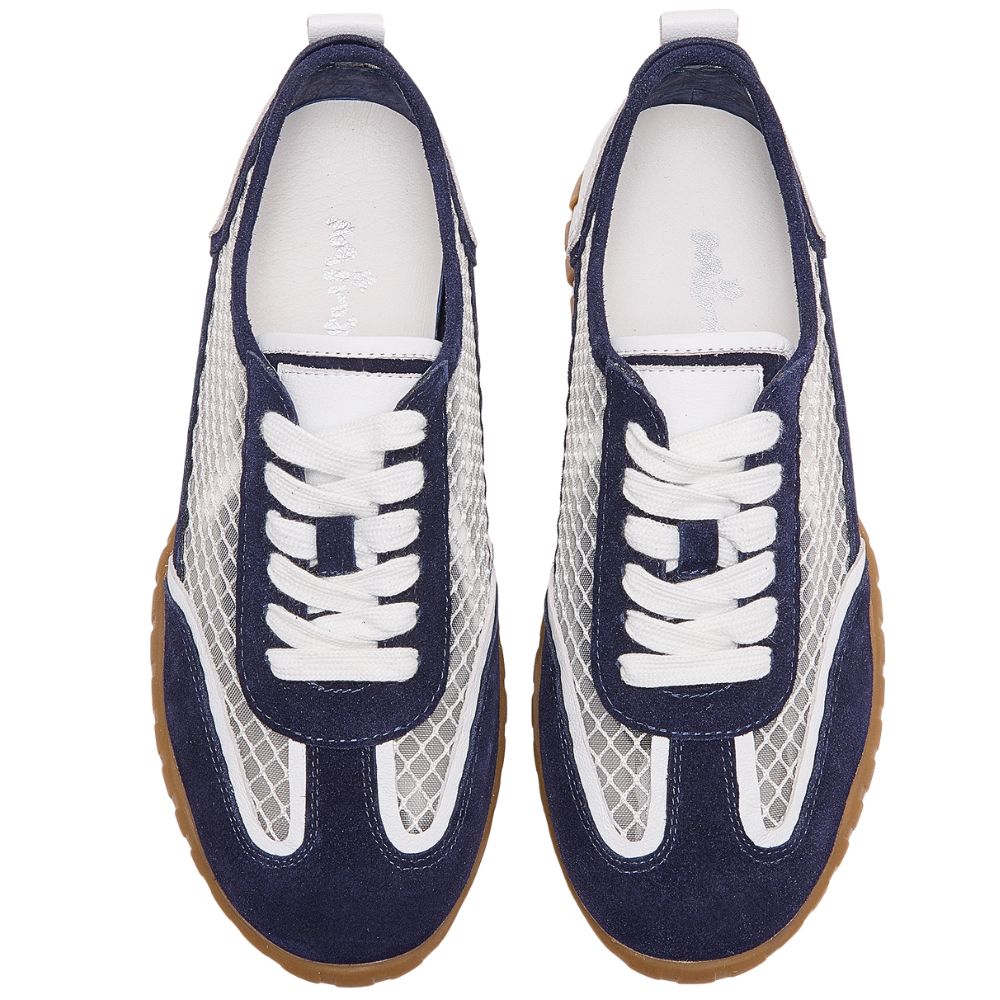 A pair of low-top sneakers shown from a top-down view, featuring navy blue suede and mesh panels, white laces, white mesh side inserts, and brown gum soles, set against a plain white background.