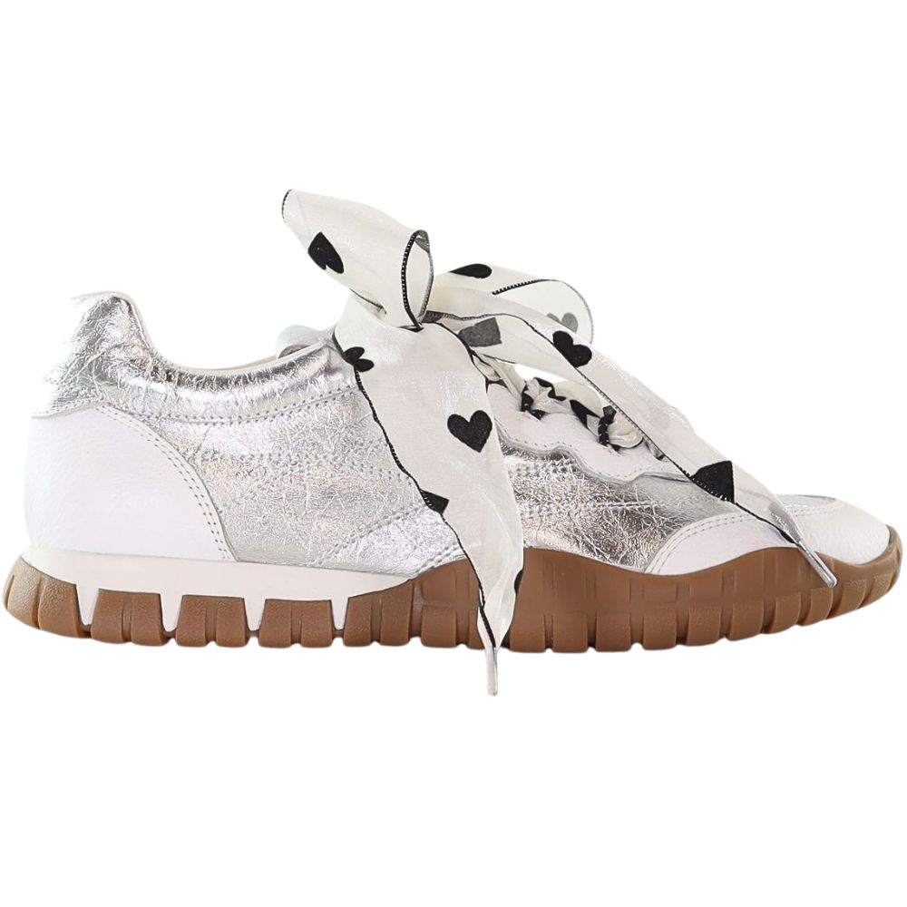 Silver and white sneakers with sheer white lace with black heart motifs on a white background