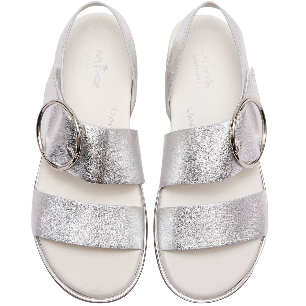 A pair of metallic silver strappy sandals with circular metal buckle ring details, shown from a top-down view on a white background.
