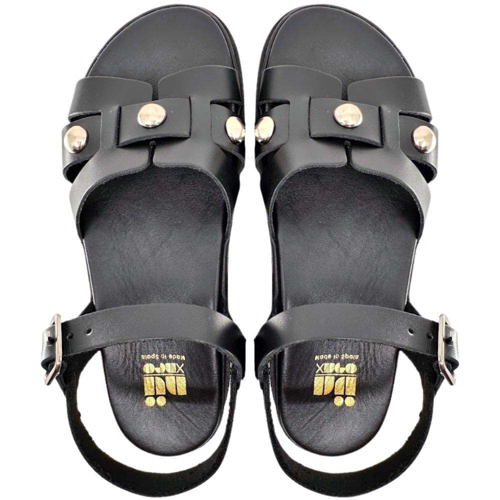 A pair of black leather slide sandals with silver metal studs and buckles, shown from a top-down view on a white background.