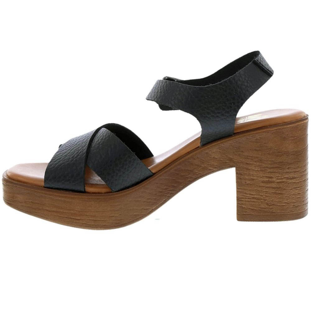 A single women's platform sandal with a chunky wooden block heel, featuring pebbled black leather straps and a light brown wood-toned platform sole, shown against a plain white background.