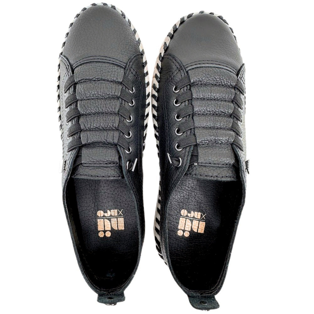 Pair of black leather sneakers on a white backgrond