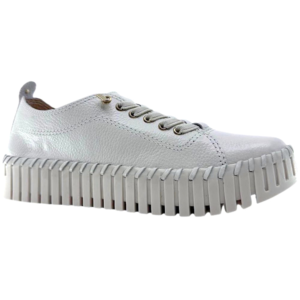 Cream leather sneaker with unique sole design on a white background