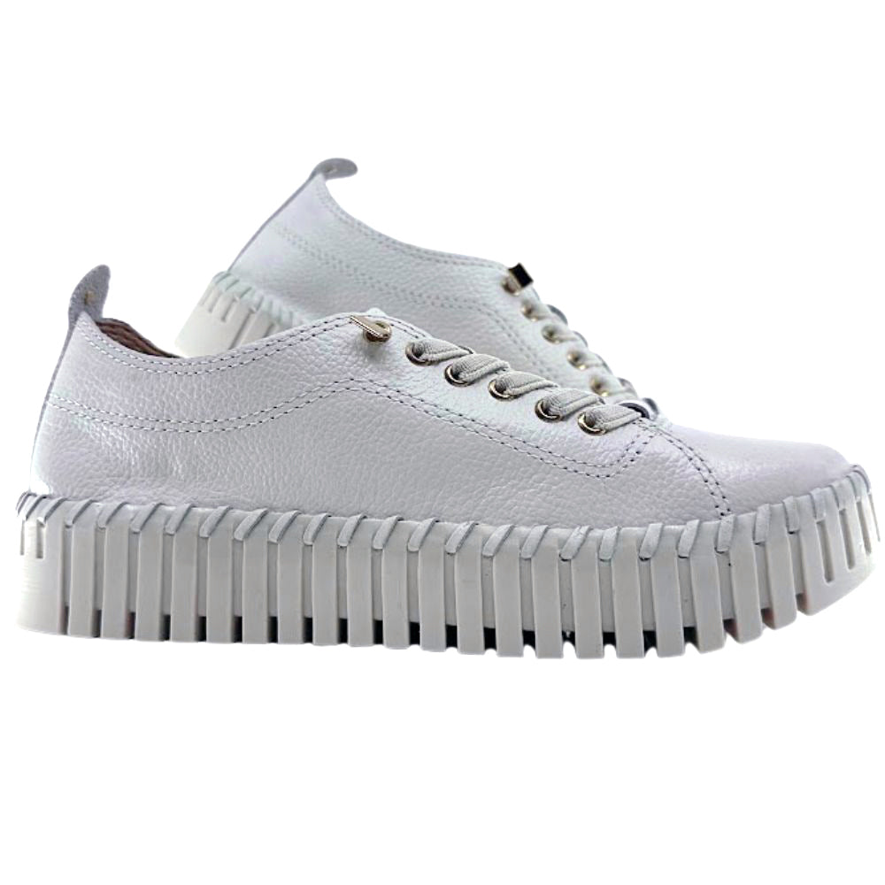 Cream leather sneakers with thick soles on a white background