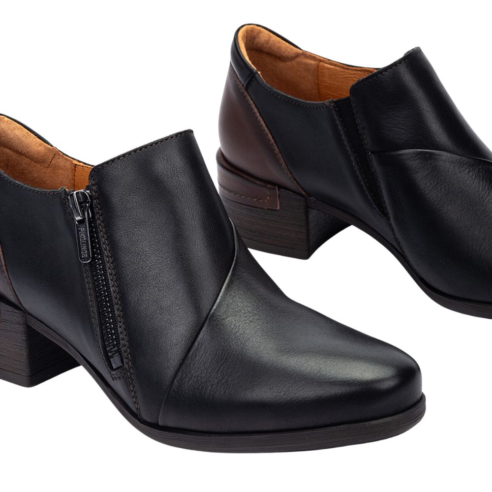 Black leather ankle boots with a zipper on a white background