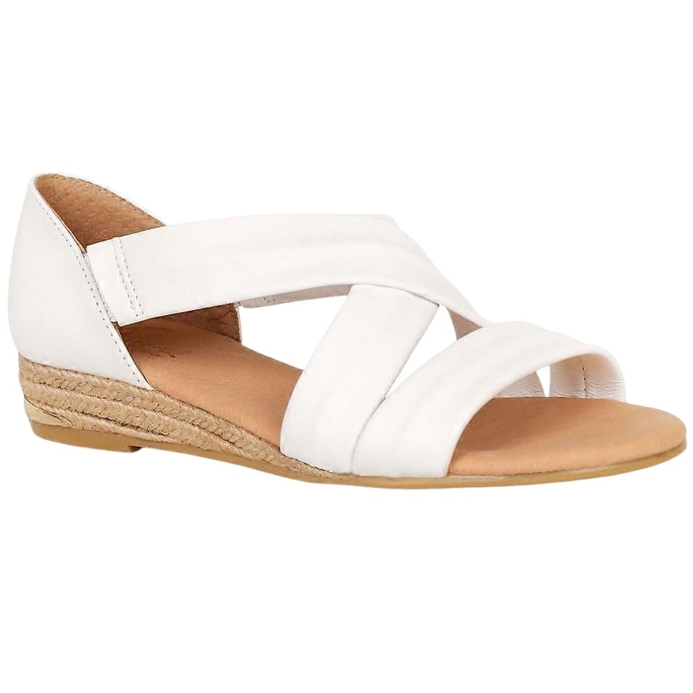 White leather sandal with a crossover design on a braided jute espadrille sole on a white background.