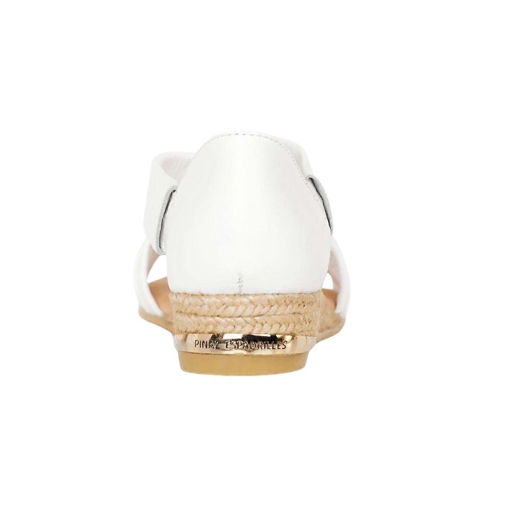 The back of a white leather espadrille sandal with a braided jute wedge heel, on a white background.