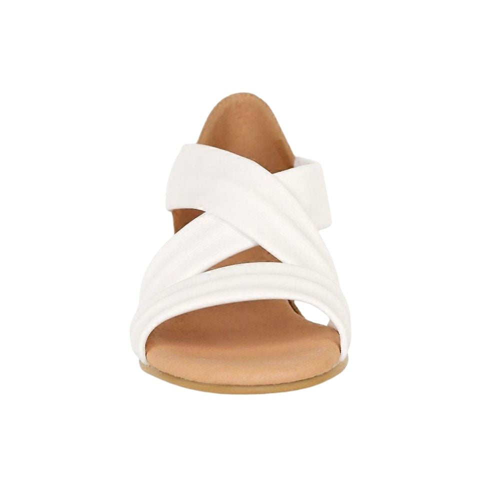 A single white strappy sandal with a tan footbed and sole, shown from a front-facing perspective on a solid white background.