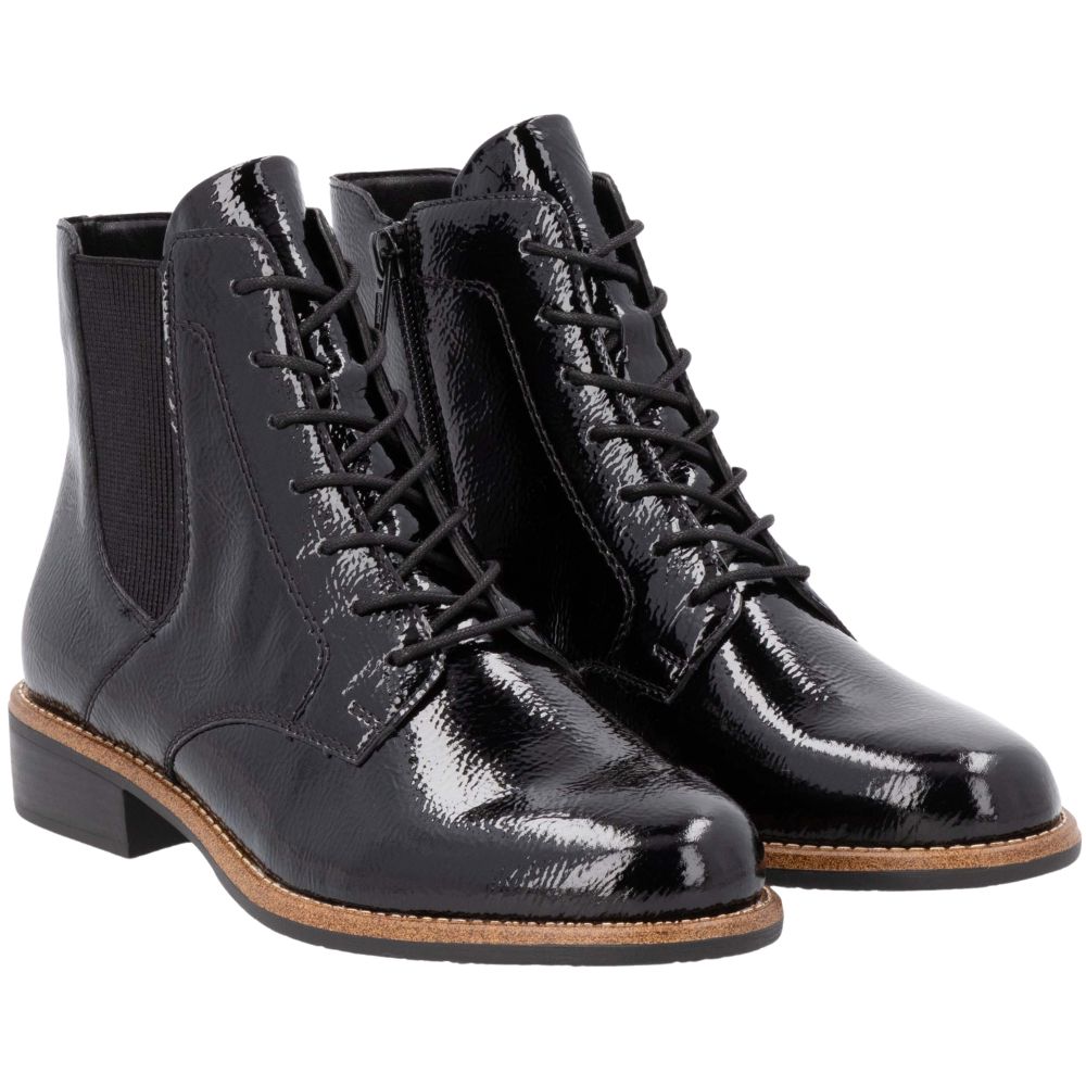 Pair of black patent leather boots on a white background
