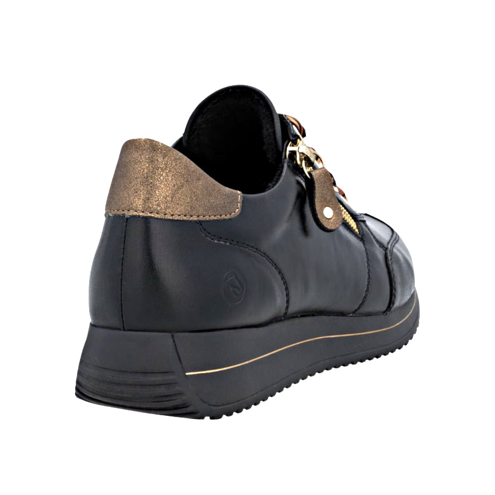Black shoe with gold accents on a white background