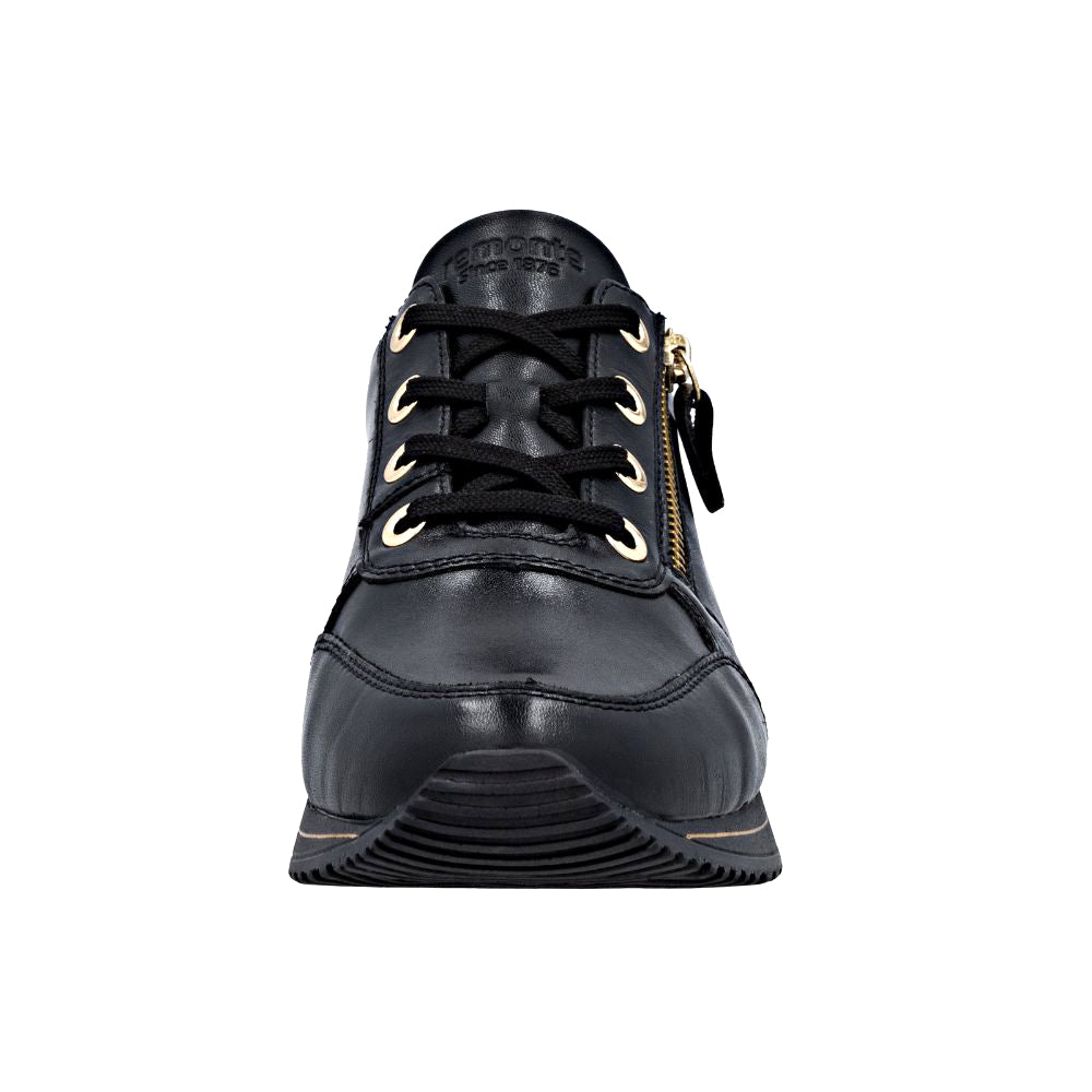 Black leather shoe with gold accents on a white background