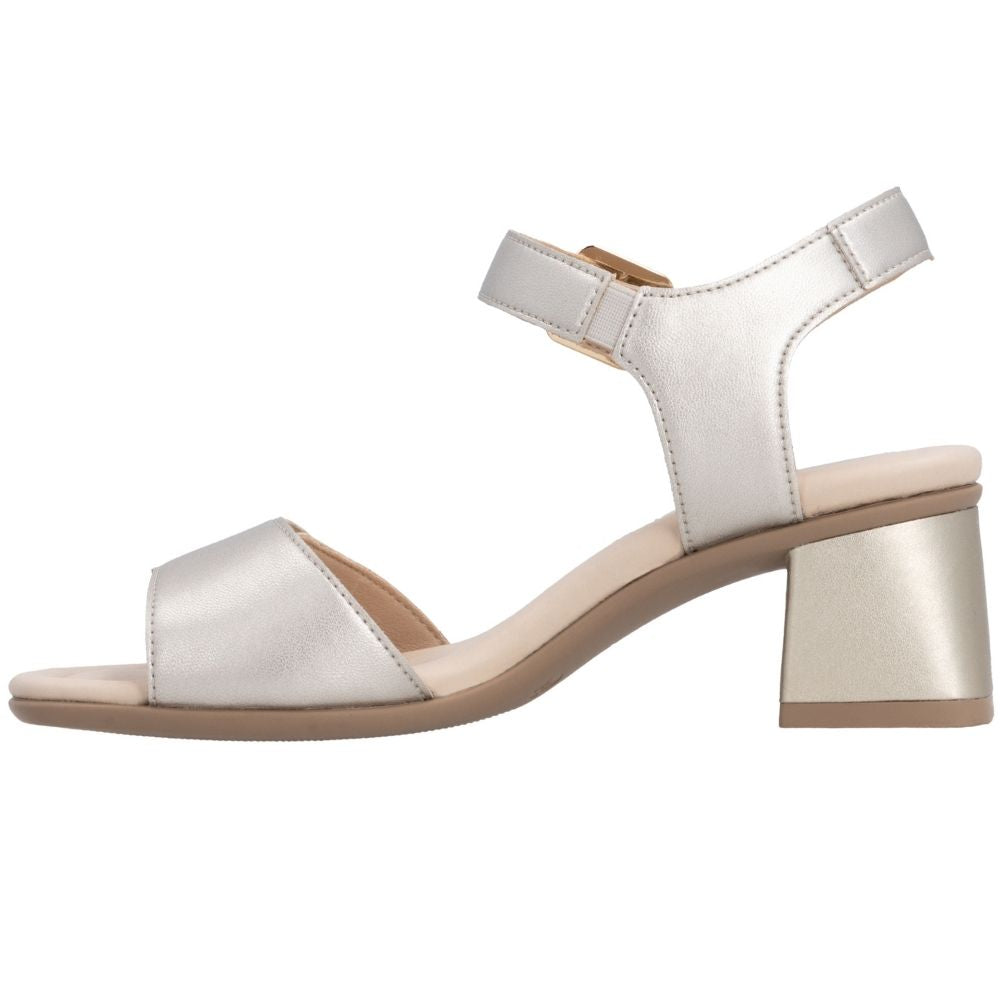 A single women's block-heel sandal in a light metallic champagne leather, featuring a low open toe, a wrap-around ankle strap with a small gold-tone buckle, and a chunky block heel, shown against a plain white background.