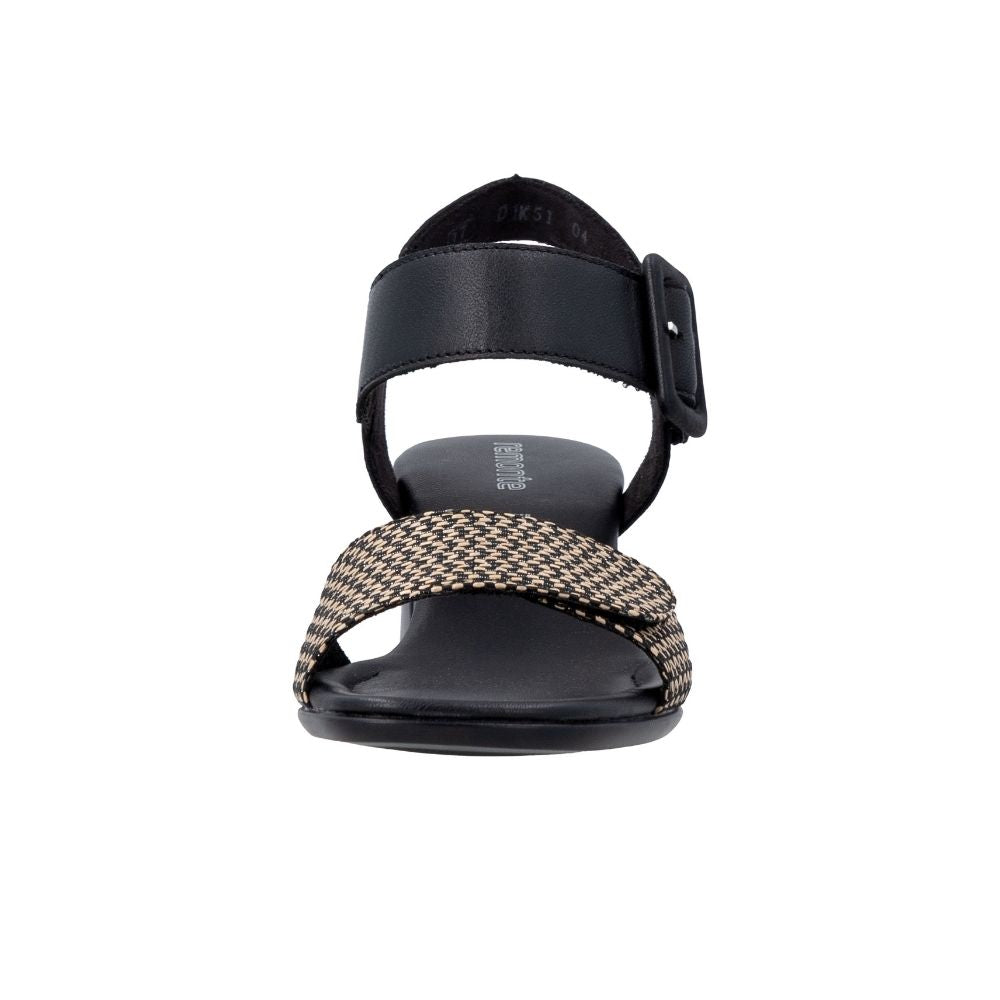 A single women's flat sandal shown from the front on a plain white background. The sandal features a black leather ankle strap with a buckle, a black footbed, and a wide woven front strap in a beige and black chevron pattern.
