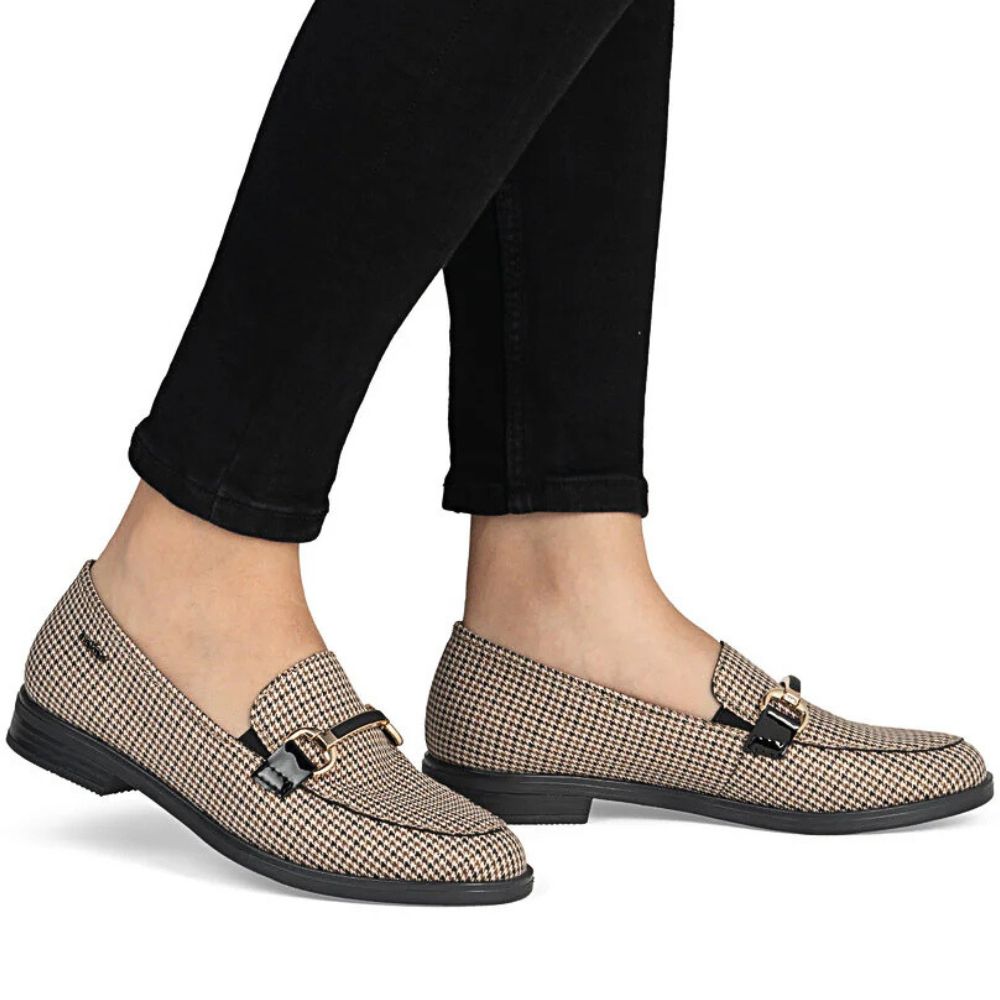 Plaid loafers worn with black pants on a white background