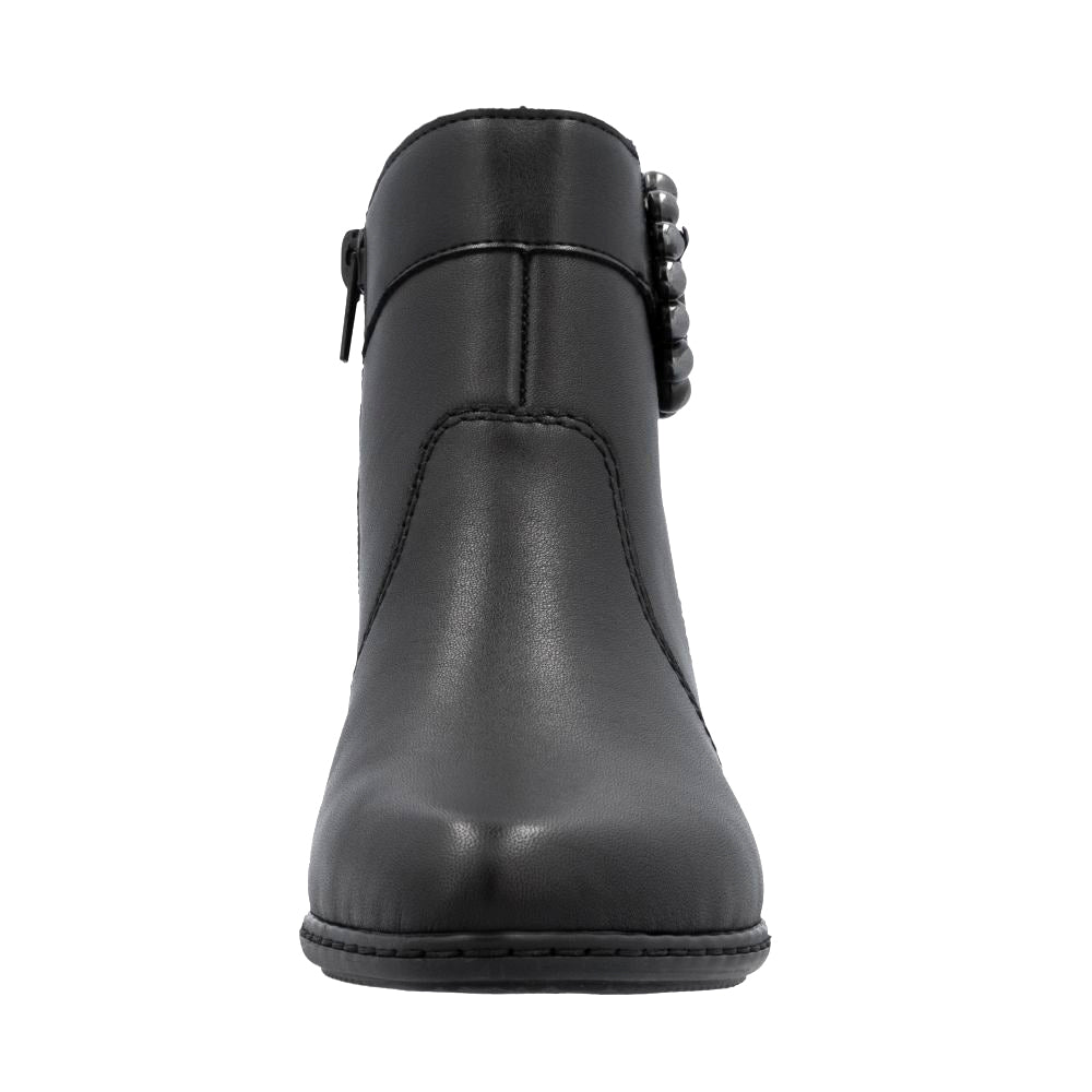 Black ankle boot with decorative buckle on a white background