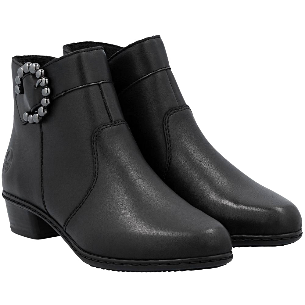 Pair of black leather ankle boots with a decorative pewter buckle on a white background