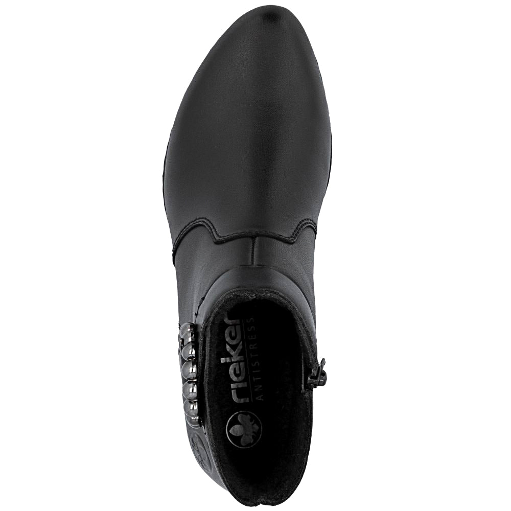 Black ankle boot with a decorative pewter buckle on a white background