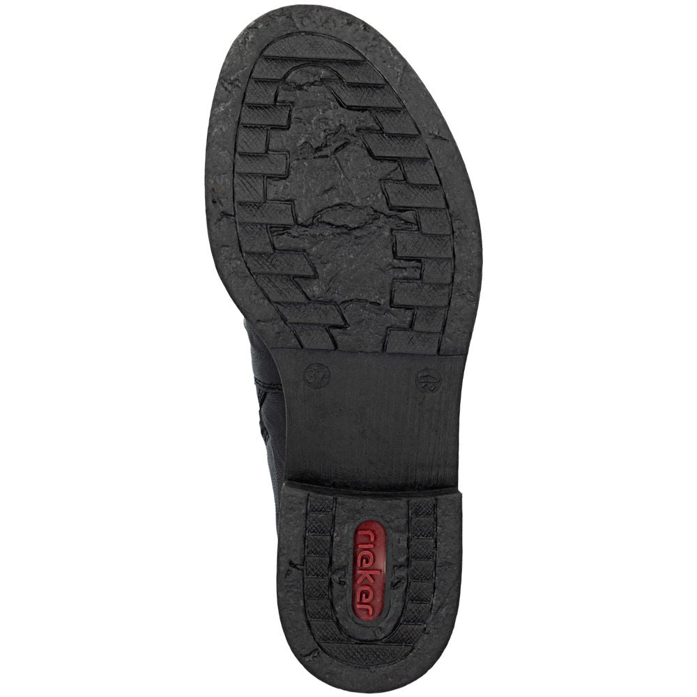 Close-up of a black shoe sole with a brand logo on a white background