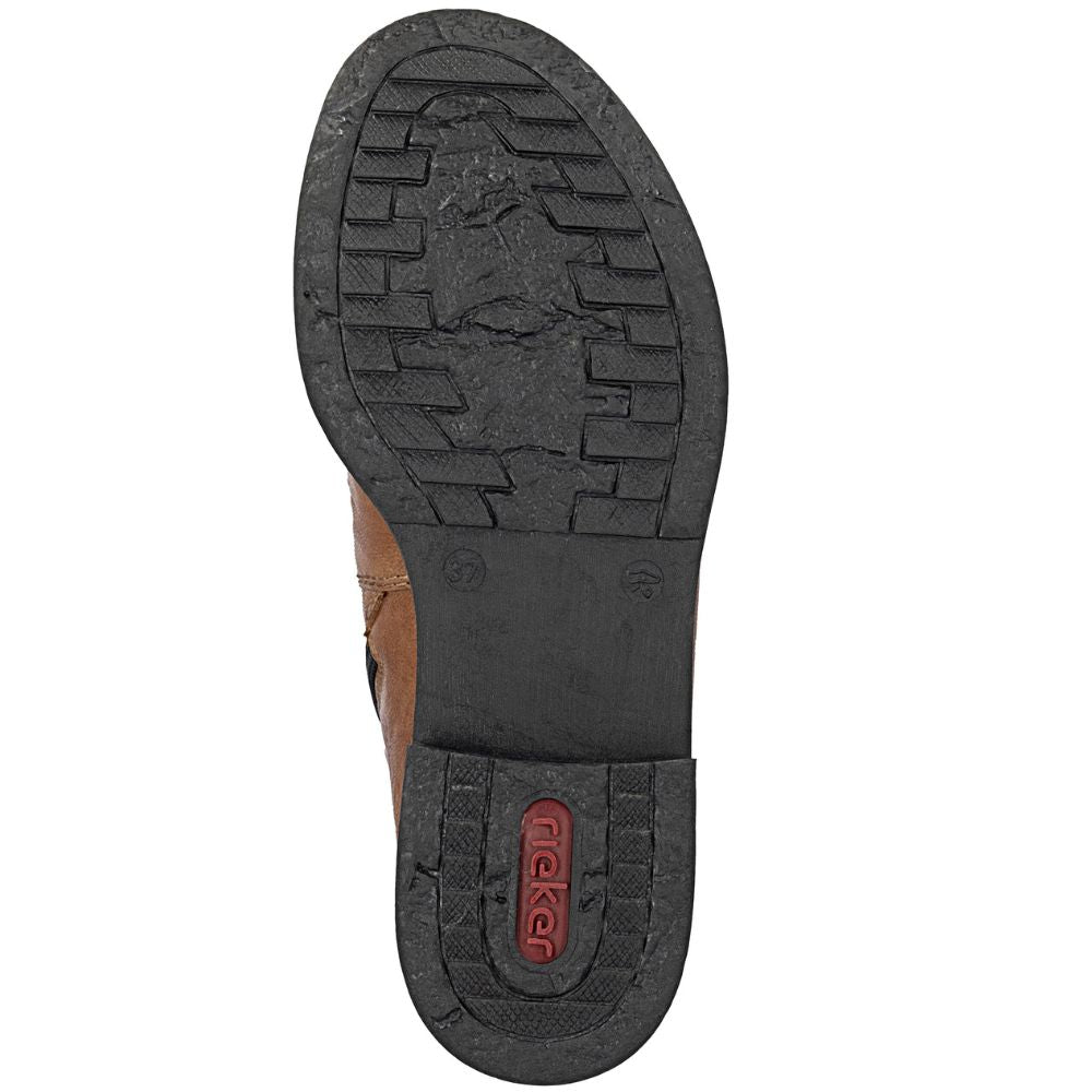 Close-up of a shoe sole with tread pattern and brand logo on a white background