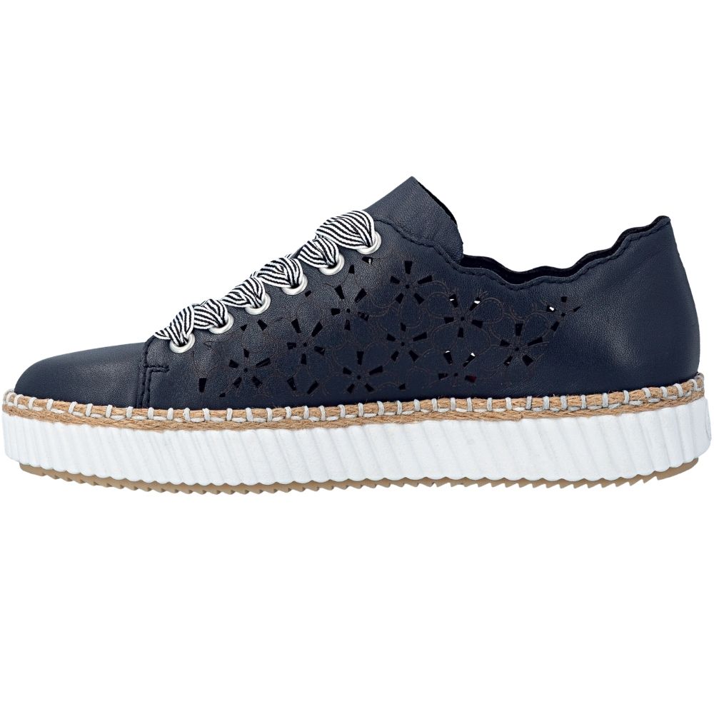 A navy-blue leather low-top sneaker with geometric laser-cutout details on the sides, featuring white and navy striped laces and a thick white ridged platform sole with a jute trim.