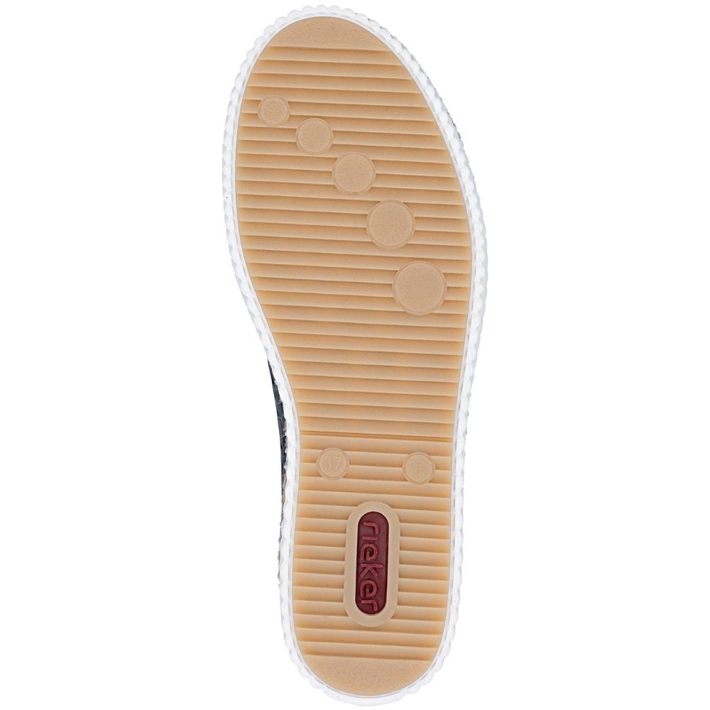 Top-down view of a shoe sole, showing a tan textured rubber outsole a small red brand tab near the heel showing 'Rieker'.