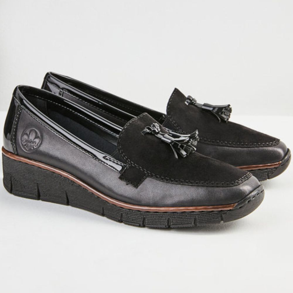 Pair of black loafers with tassels on a white background