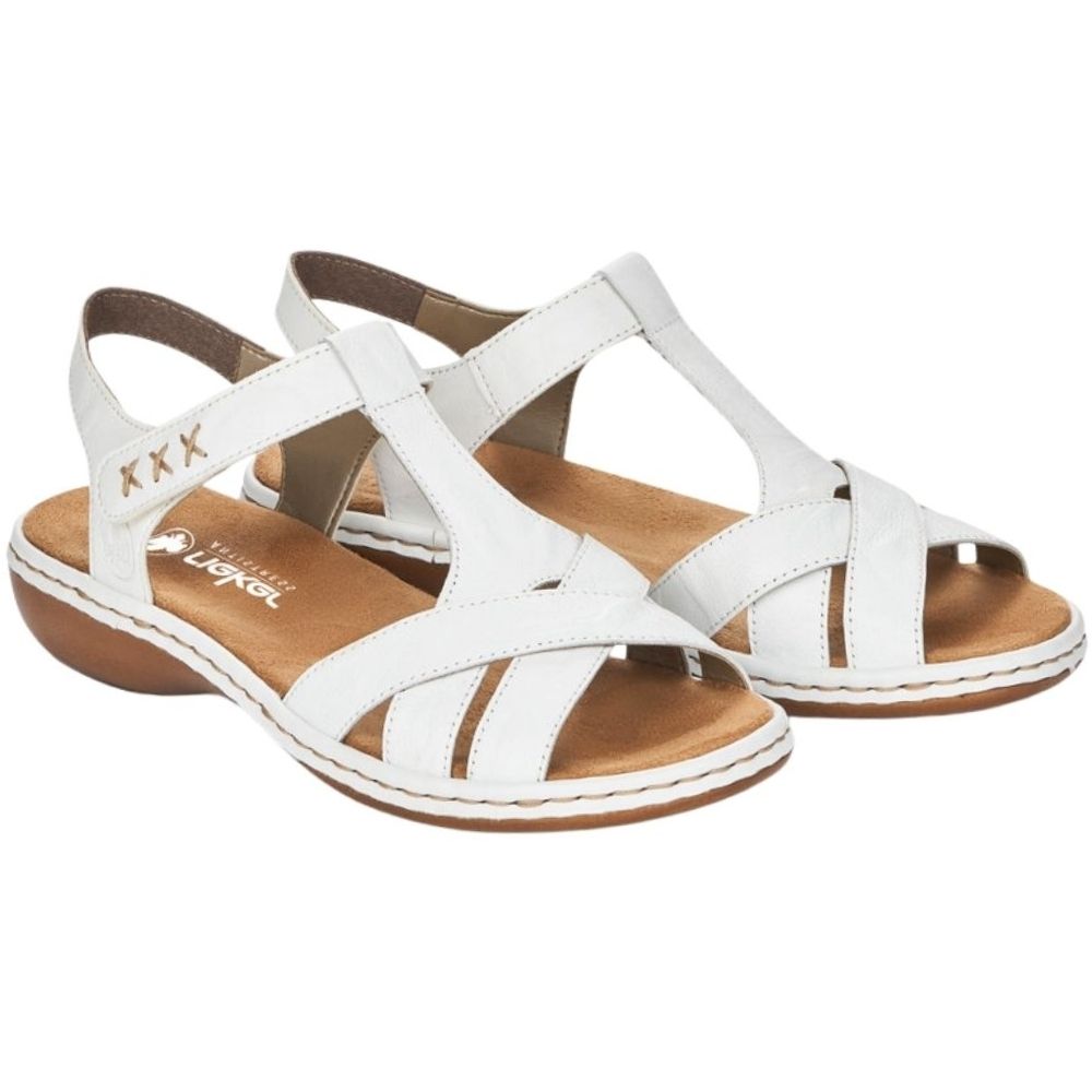 A pair of white leather T-strap sandals with brown footbeds and brown soles, shown on a plain white background.