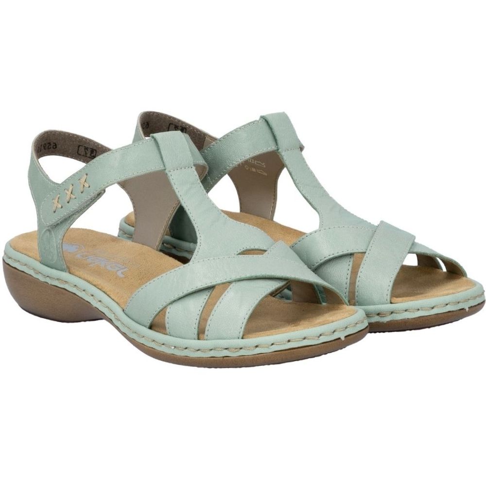 A pair of women's T-strap sandals in a light sage green color, featuring a brown contoured sole and a tan footbed, shown against a plain white background.