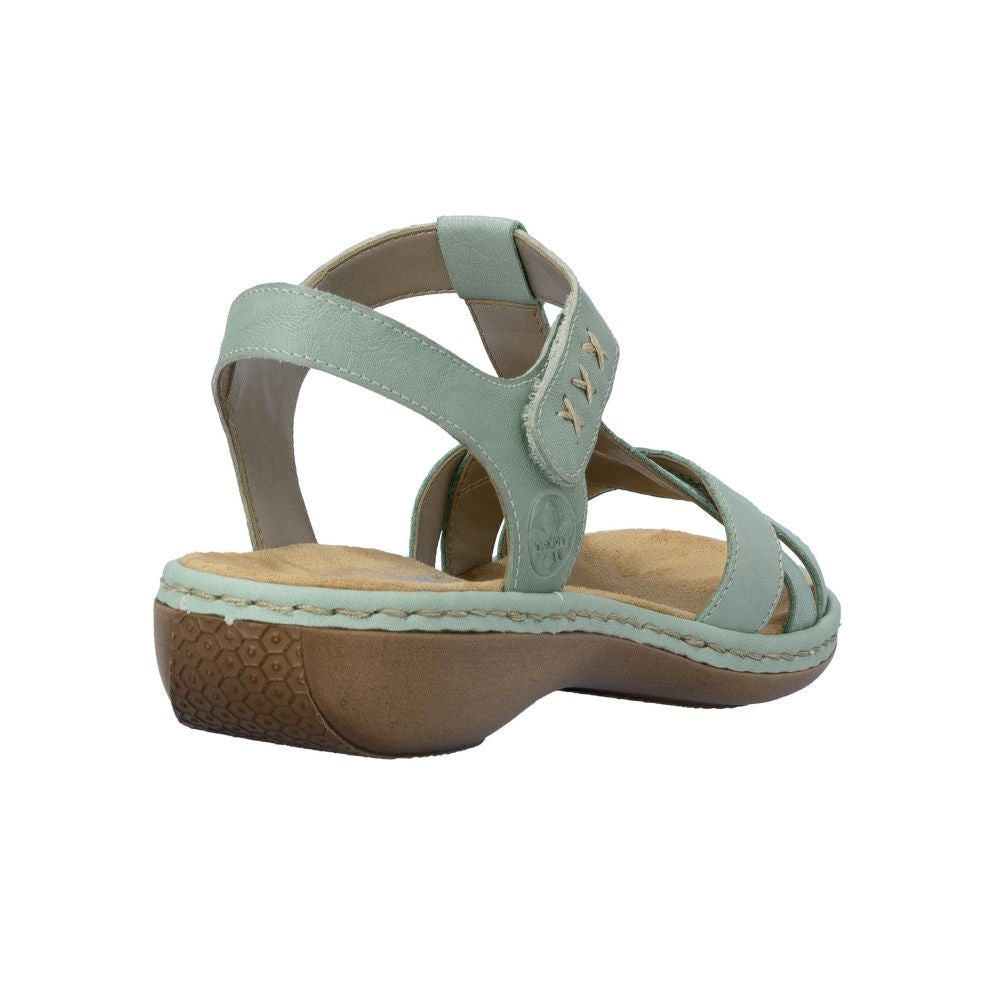 A light sage green leather wedge sandal with an adjustable ankle strap and a brown textured sole, shown from a side angle on a white background.