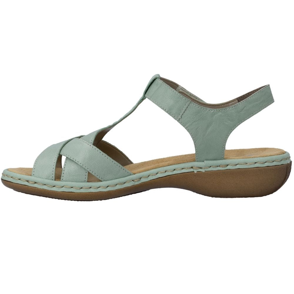 A light sage green T-strap sandal with a brown wedge sole, shown in a side profile view against a plain white background.