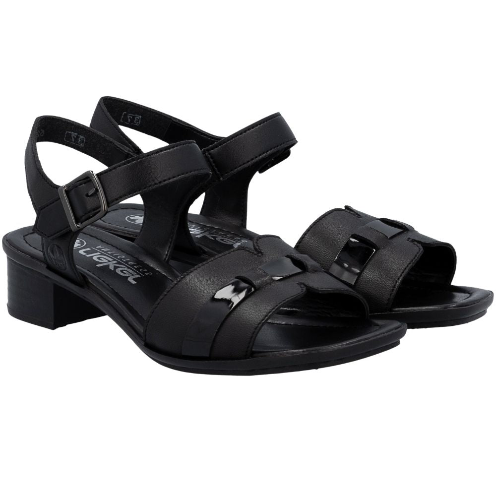 A pair of black leather block-heel sandals with an adjustable ankle strap and a decorative patent leather accent on the front strap, shown in an angled profile view against a white background.