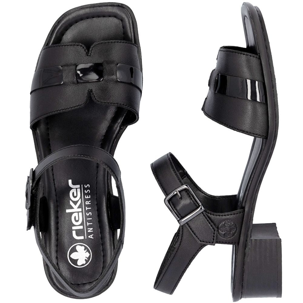 A pair of black leather block-heel sandals with an adjustable ankle strap and a decorative patent leather accent on the front strap, shown in a top-down profile view against a white background.