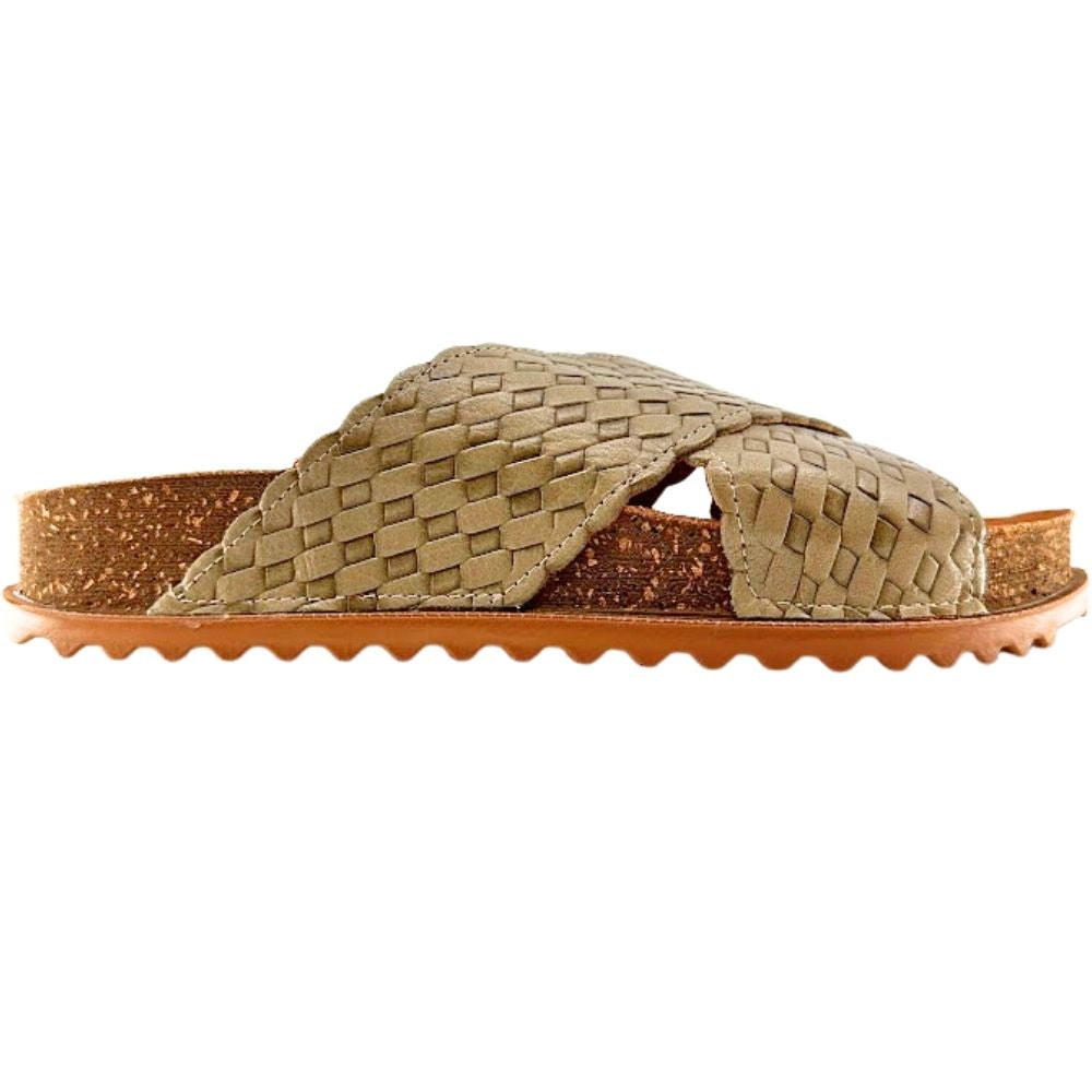 A single woven slide sandal with textured sage woven leather straps, a brown cork-look midsole, and a wavy brown outsole, shown against a plain white background.