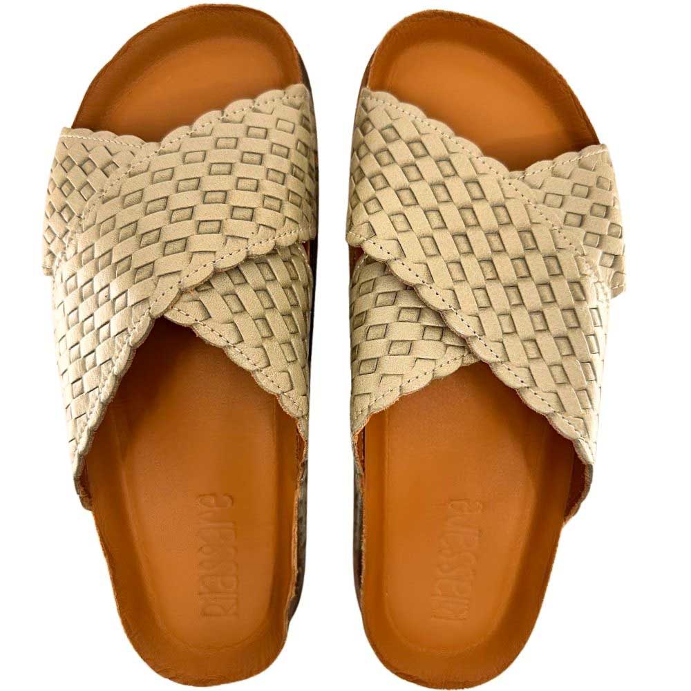 A pair of women's slide sandals with woven sage leather straps and a contoured tan footbed, shown from a top-down view on a white background.