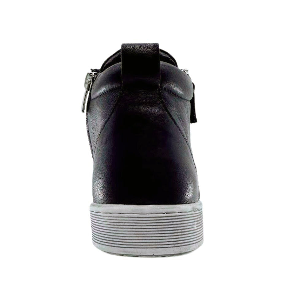 Black high-top sneaker boot with a white sole on a white background